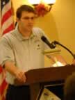 Rebel Head Coach Lucas Jones thanks the fans attending the banquet for their support. Image